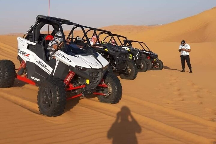 Experience the thrill of driving through the stunning Al Lahbab Desert navigating sandy dunes and creating unforgettable memories with every turn on a powerful quad bike.